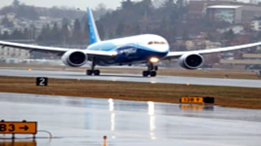 A Boeing 787 Dreamliner lands after its long-waited first flight.