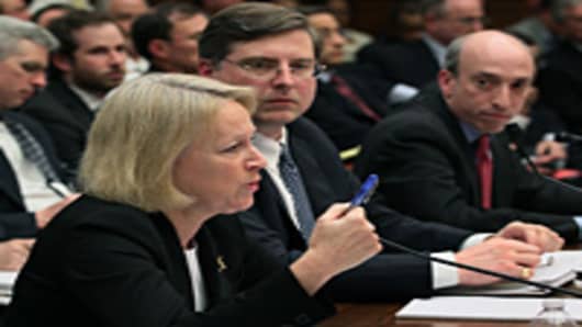 Mary Schapiro, chairman of the Securities and Exchange Commission, Robert Cook, director of the SEC's Division of Trading and Markets and Gary Gensler, chairman of the Commodity Futures Trading Commission participate in a House Financial Services Committee hearing Tuesday on Capitol Hill.