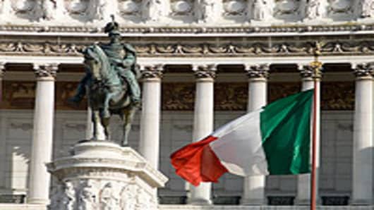 Statue and Italian Flag in front of Vittorio Emanuele monument.