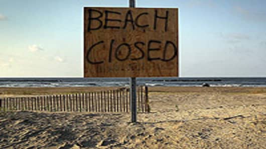 A sign warns the public away from the beach on Grand Isle, Louisiana. With oil covering many of the beaches, officials closed them to the public indefinitely on Saturday. Officials now say that it may be impossible to clean the coastal wetlands affected by the massive oil spill that continues gushing in the Gulf of Mexico.