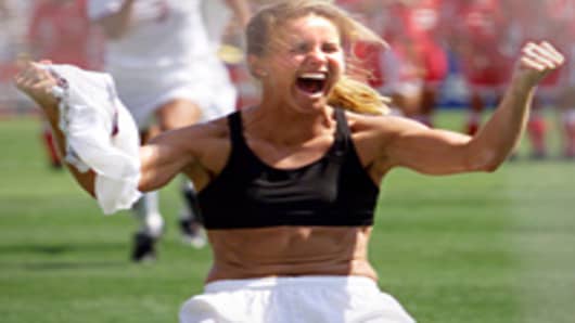 Brandi Chastain shouts after falling on her knees after she scored the last goal in a shoot-out in the finals of the 1999 Women's World Cup against China.