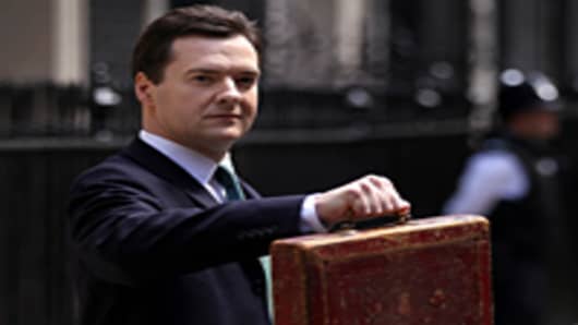Chancellor of the Exchequer George Osborne holds Disraeli's original budget box as he leaves 11 Downing Street for Parliament.