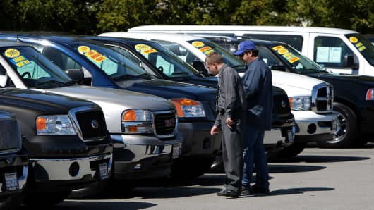 man looking at used cars for sale