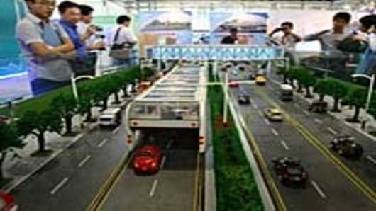 Viewers take in a scale model of China's 3D Fast Bus.