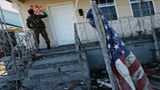 Marine from Camp Lejeune, N.C., marks a home to indicate he found no occupants as houses in the lower Ninth Ward are checked for bodies or people who are still stranded more than two weeks after Hurricane Katrina hit.