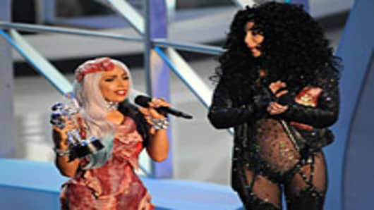 Lady Gaga accepts award from Cher on stage at the 2010 MTV Video Music Awards.