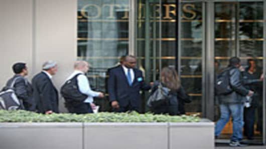 Lehman Brothers' employees arrive at work on September 19, 2008 in London, England. For many employees at the American investment bank, today is their final payday following Lehman Brothers going into administration earlier this week.