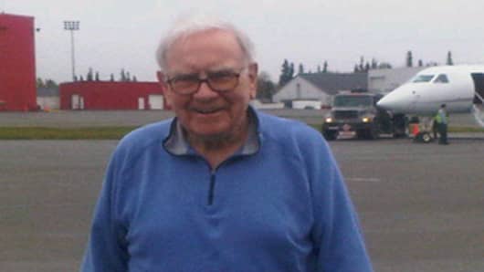 Warren Buffett poses for a picture during a refueling stop in Alaska as he leads a Berkshire Hathaway delegation to China.