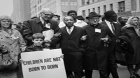 Civil rights leader Rev. Martin Luther King, Jr. is accompanied by famed pediatrician Dr. Benjamin Spock, Father Frederick Reed and union leader Cleveland Robinson 16 March, 1967, during an anti-Vietnam War demonstration in New York.