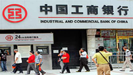 Pedestrians walk past a branch of the Industrial and Commercial Bank of China (ICBC) in central Beijing.