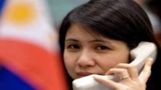 A trader talks on the phone on the trading floor of the Philippine Stock Exchange.