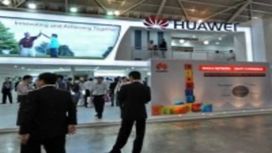 People visiting Huawei Technologies booth display of its product during CommunicAsia 2010 conference and exhibtion show in Singapore.
