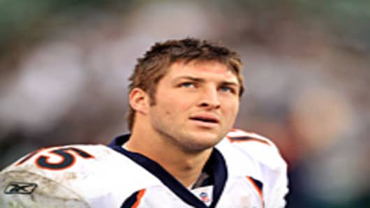 Tim Tebow of the Denver Broncos stands on the sideline during their game against the Oakland Raiders at Oakland-Alameda County Coliseum on December 19, 2010.
