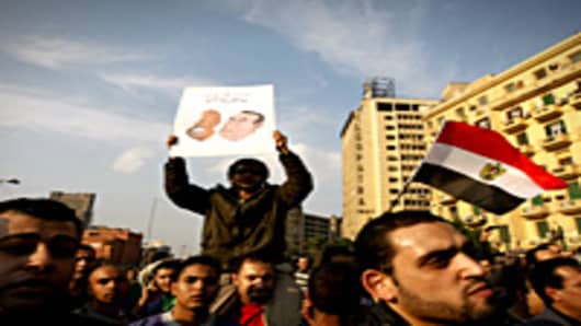 Egyptian demonstrators hold up placards during a protest in central Cairo to demand the ouster of President Hosni Mubarak and calling for reforms.