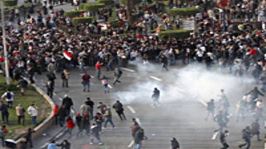 Egyptian demonstrators protest in central Cairo amidst tear gas fire by Egyptian police to demand the ouster of President Hosni Mubarak and calling for reforms.