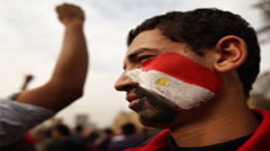 A youth with an Egyptian flag painted on his face stands in Tahrir Square in Cairo, Egypt.