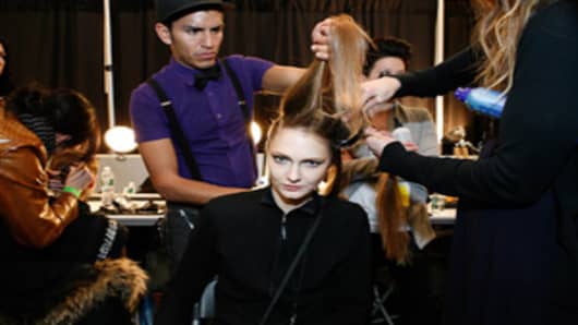 A model gets her hair and makeup done backstage at the Irina Shabayeva fashion show in New York City's Lincoln Center.