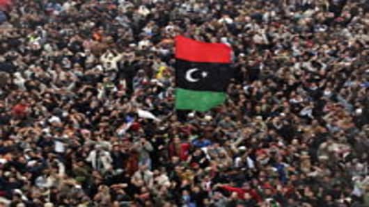 BENGHAZI, LIBYA - FEBRUARY 25: Libyans protest demanding the removal of Libyan leader Muammar Gaddafi following Friday prayers on February 25, 2011 in Benghazi, Libya. Benghazi residents mourned more victims of the violence as fighting continued around the capitol Tripoli.