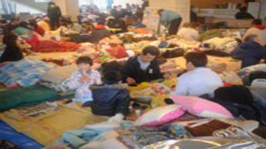People take shelter at an evacuation centre in Natori, Miyagi prefecture on March 16, 2011.