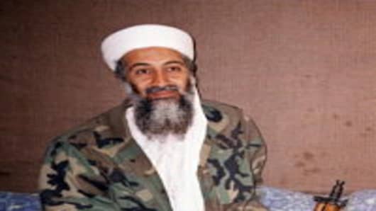 Saudi-dissident Osama Bin Laden sits on floor with his AK-47 rifle in his hide outs in Afghanistan 08 November, 2001. Osama bin Laden in an interview with a Pakistani newspaper denied reports he had been hospitalized in Dubai for kidney treatment.