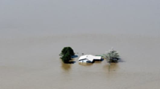 Floodwater engulfs a home after the Army Corps of Engineers blew a massive hole in a levee at the confluence of the Mississippi and Ohio Rivers to divert water from the town of Cairo, Illinois May 3, 2011 near Wyatt, Missouri.