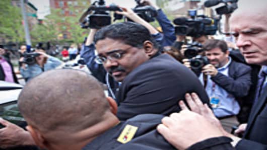 Raj Rajaratnam, confronted by media as he leaves the Daniel Patrick Moynihan United States Court House at 500 Pearl Street after being found guilty of 14 charges against him on May 11, 2011 in New York City. After eleven days of deliberation a jury convicted Rajaratnam with all 14 counts of securities fraud and conspiracy.