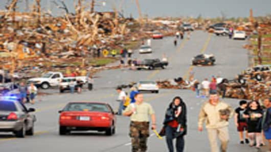 Residents walking down street after a tornado in Joplin, Missouri.