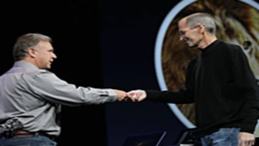 Apple CEO Steve Jobs bumps fists and hands the stage over to Senior Vice President of Worldwide product marketing Phil Schiller.