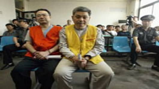 Zhang Xiaochuan (L) and his younger brother Zhang Tiansheng stand trial on corruption charges in 2005 in Shaanxi Province. Zhang Xiaochuan, a former official of the Ministry of Propaganda in Chongqing, and Zhang Tiansheng were accused of embezzling millions of yuan and abusing power over 5 years.