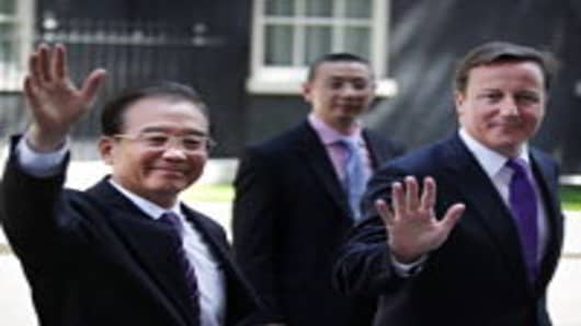 British Prime Minister David Cameron (R) leaves Downing Street with Chinese Premier Wen Jiabao to attend a press conference at The Foreign Office on June 27, 2011 in London, England. British businesses are expected to sign multi-million pound deals when the two leaders meet at Number 10.