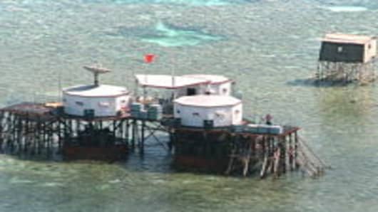 China's flag flies over octagonal structures built on stilts in the Philippine-claimed Mischief Reef in the disputed Spratly Islands located in the South China Sea.