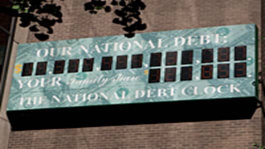 'The National Debt Clock ' is displayed on the side of a building near an Internal Revenue Service office in New York.