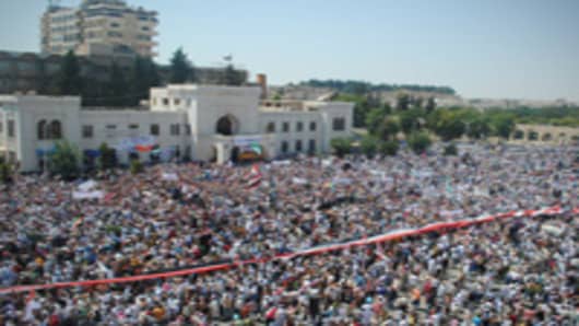 Syrians demonstrate against the government after Friday prayers in Hama on July 29, 2011