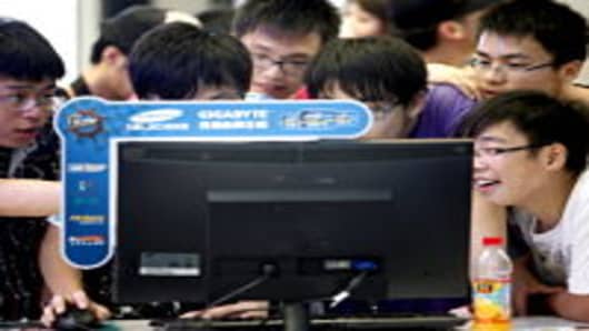 Teenagers surround a computer screen at the ChinaJoy Expo, also known as the China Digital Entertainment Expo and Conference, in Shanghai, China.