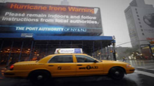 A taxi passes by a warning sign on the side of the Port Authority in New York on August 28, 2011 as Hurricane Irene hits the city and the Tri State area with rain and high winds. Irene weakened to tropical storm status Sunday as it hit New York City.