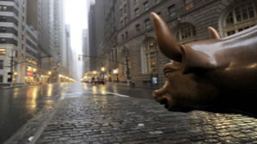 The Wall Street bronze Bull looks out to an empty Broadway in Lower Manhattan, New York, early August 28, 2011 as Hurricane Irene hits the city and Tri State area with rain and high winds.