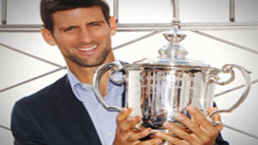2011 US Open Singles Men's Champion Novak Djokovic of Serbia poses with his trophy atop the Empire State Building on September 13, 2011 in New York City, New York.