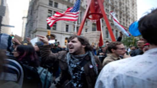 People scream at the New York police officers after an arrest was made on Broadway in front of Zuccotti Park, where demonstrators protesting against the financial system are gathering on September 19, 2011 in New York City.