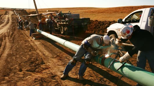 A crew from Alpha Oil & Gas Services Inc. constructs a 10 inch gas pipeline outside of Watford City, North Dakota, U.S