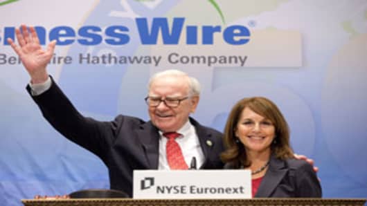 Warren Buffett and Business Wire CEO Cathy Baron Tamraz on the Opening Bell podium of the New York Stock Exchange, September 30, 2011.
