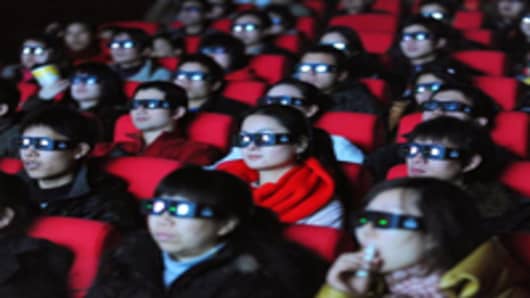 Chinese movie-goers wear 3-D glasses