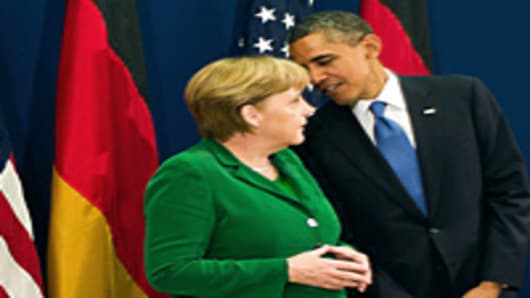 German Chancellor Angela Merkel and US President Barack Obama talk ahead of the start of the G20 Summit of Heads of State and Government on November 3, 2011 in Cannes, France.