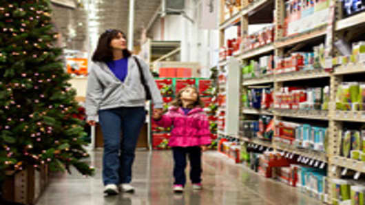 Customer Lynn Leonard, left, and her daughter Meghan Leonard, 4, walk through the holiday decorations area at a Home Depot Inc. store in Charlotte, North Carolina.