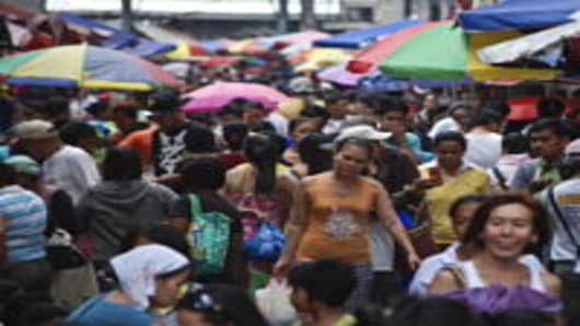 People walk on a busy street in Quiapo on October 28, 2011 in Manila, Philippines. The United Nations today released their 2011 State of the World Population Report, which indicates Asia is home to 60 per cent of the world's population. The Philippines has a young population, with 54 per cent of the population under 25.