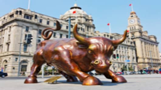 Bull statue symbolizing the stock market on the Bund, Shanghai, China.