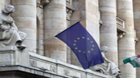 A European Union, left, and a Hungarian national flag, fly outside the Magyar Nemzeti Bank, Hungary's central bank, in Budapest.