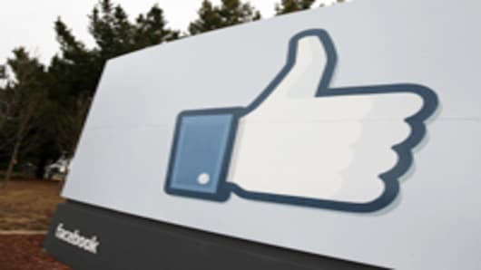 A sign with the 'like' symbol stands in front of the Facebook headquarters in Menlo Park, California.