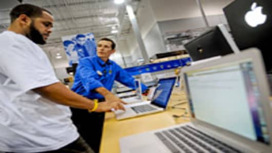 Marc White, left, asks Best Buy employee Steve Buckner questions about an Apple MacBook Pro laptop computer at a Best Buy store in Atlanta, Georgia, U.S.