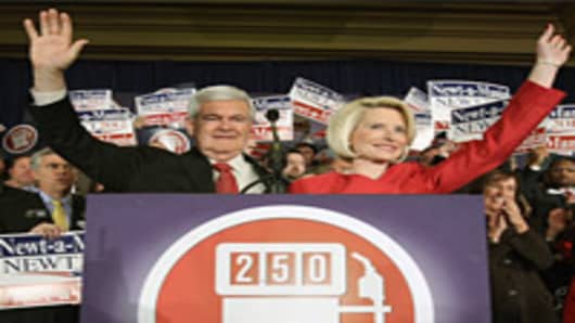 Republican presidential candidate Newt Gingrich and his wife Callista Gingrich wave after being declared the winner of the primary in Georgia during the election night rally at the Renaissance Atlanta Waverly Hotel on March 6, 2012 in Atlanta, Georgia