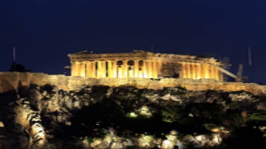 The Parthenon, illuminated at night, sits at the top of Acropolis hill in Athens, Greece, on Monday, Feb. 13, 2012.